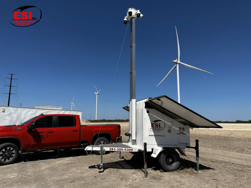 Solar-powered mobile security trailer protecting an off-grid energy installation