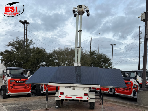 Solar-Powered Security Trailer with elevated surveillance cameras and solar panels reducing operating costs at commercial site