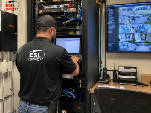 technician evaluating an existing commercial security system for a security system takeover